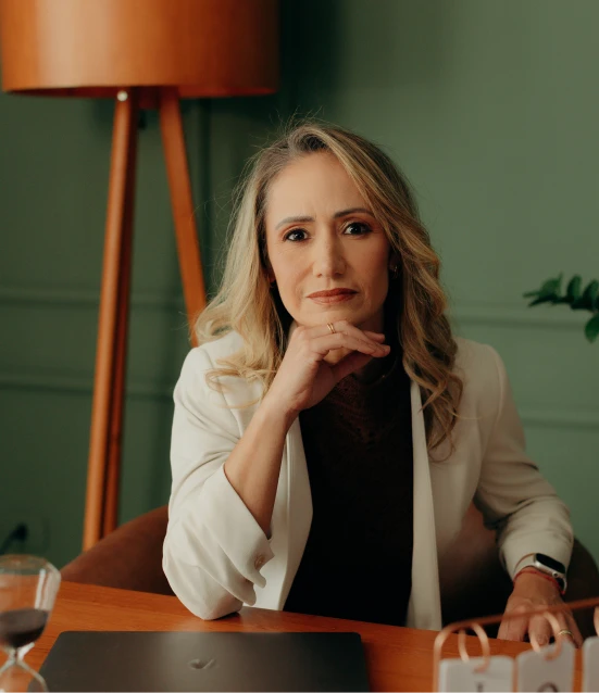 Dra. Anna Carolina Passos Waknin em seu consultório, de blazer branco